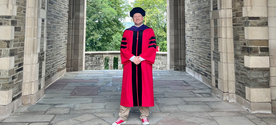 Uriah Nalikak stands on the campus of Cornell University Law School following the summer 2023 commencement exercises.