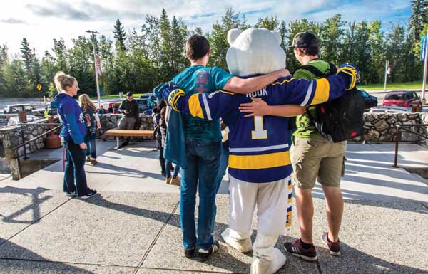 Students at MBS complex pose with the Nanook mascot